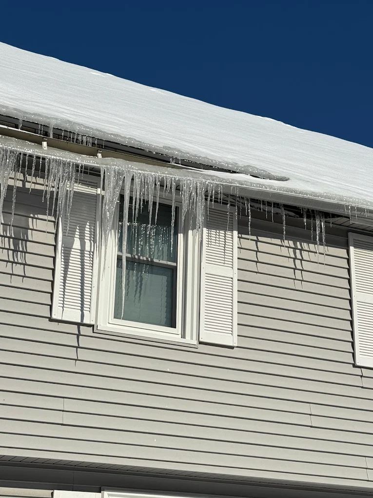 Icicles hanging from a roof edge in winter