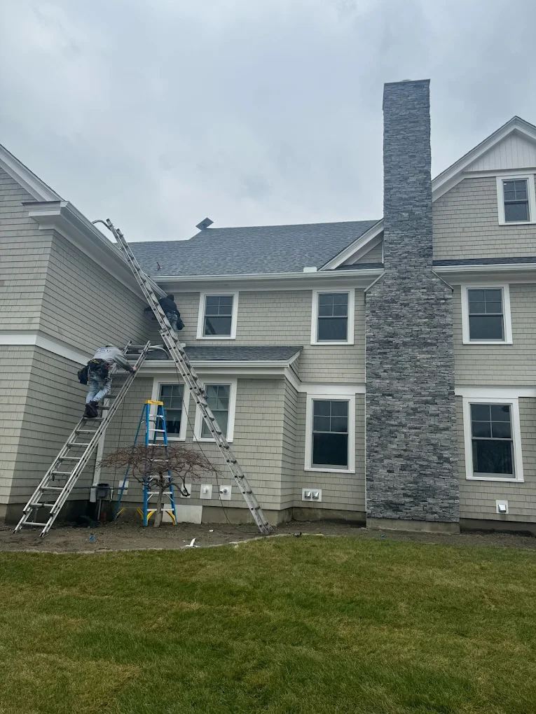 Mr. Gutter crew installing gutters on a home