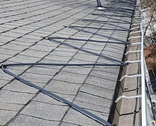 Heat cables installed in a zigzag along a roof edge