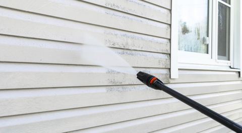 Vinyl siding being power washed